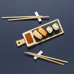 A wooden sushi serving set featuring various sushi pieces, a small bowl of soy sauce, and chopsticks on a dark surface.