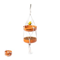 A bird feeder made of orange plastic with two tiers and a small yellow bird figurine perched on top. It has a branded logo.