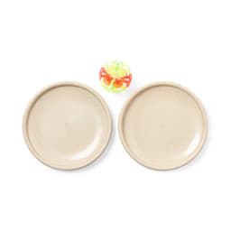 Two beige plates and a colourful ball are displayed centrally in the image. The plates have a simple design and a smooth finish.