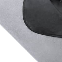 A grey picnic rug with a black border and a logo. The fabric has a subtle textured pattern.