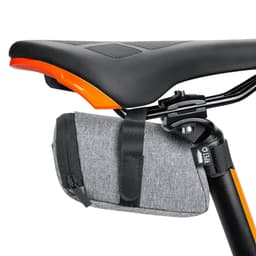 A grey Ritok Bag is attached under a bike saddle, featuring a zipper and a simple design.