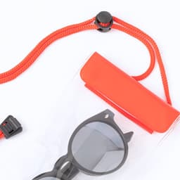 A transparent dry bag in clear and orange, featuring a black pair of sunglasses inside. The bag has a logo and a drawstring closure.