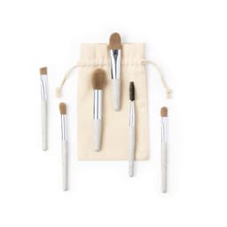 A set of six makeup brushes with beige handles, displayed with a natural fabric storage pouch.