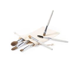 A set of makeup brushes with beige handles and silver accents, presented in a cream fabric pouch.