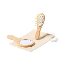 A bamboo hairbrush and mirror set on a beige pouch, featuring a natural wood finish.