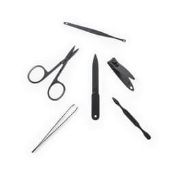 A collection of black grooming tools, including scissors, tweezers, a nail file, a clipper, and a cuticle pusher.