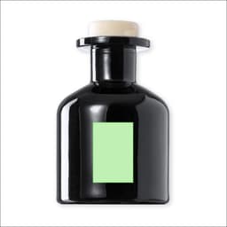 A black aromatic diffuser bottle with a green label and a white top, featuring a circular opening.