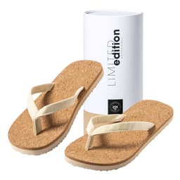 A pair of beige thongs with a cork sole and a white strap, displayed alongside a cylindrical white packaging.