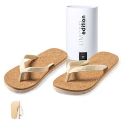 A pair of beige thongs with a cork footbed and a white box featuring a logo.