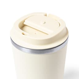 An insulated cup in cream with a silver band and a flip-top lid. It features a logo on the side.
