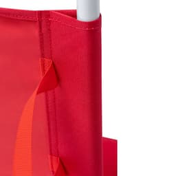 A close-up of a red fabric and frame detail of the Coswel Chair, featuring stitching and straps.