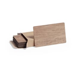 A set of wooden business cards displayed in a brown kraft paper box. The cards have a natural wood finish.