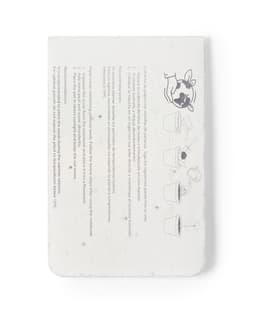A sticky note pad featuring an eco-friendly design with a white background and dark illustrations. It includes a logo.