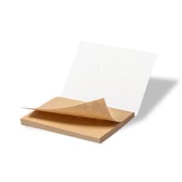 A brown sticky note pad with a single note partially lifted, featuring a textured white surface.