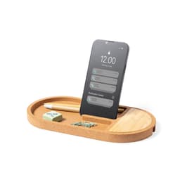 A wireless charger in a cork base with a phone dock, pen, eraser, and paper clips, featuring a natural colour scheme.