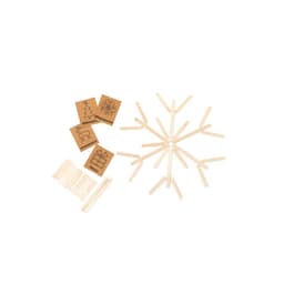 A set of wooden sticks arranged in a snowflake pattern, with cards featuring festive designs nearby.