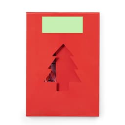 A red gift box with a cut-out Christmas tree design and a green label area.