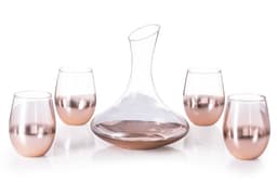 A glass decanter and four matching rose gold gradient wine glasses. The set features elegant, curved designs.