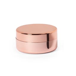A rose gold lip balm container with a smooth round lid and a shiny finish. It features a simple, elegant design.