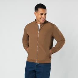 A brown jacket with a zip front, featuring a stand-up collar and two front pockets. The model is smiling while wearing it.