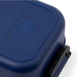 A navy blue lunch box with a lid, featuring a food grade label and a secure clip closure.