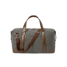 A grey canvas bag with brown leather accents and detachable strap, featuring top handles and a zippered pocket.