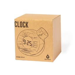 A circular desk clock with a digital display, packaged in a brown cardboard box. Features a minimalist design and a logo.