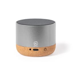 A silver and cork Bluetooth speaker with a textured surface and a logo on the front. It features a USB-C port and power button.