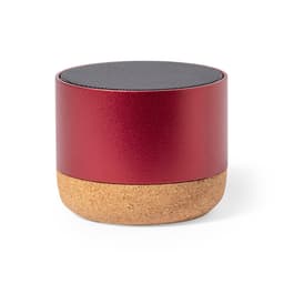 A round red Bluetooth speaker with a cork base and a mesh top. It features a logo on its body.