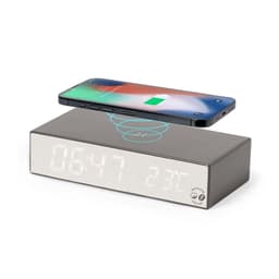 A wireless charger in grey with a digital clock display, featuring a smartphone positioned above it.