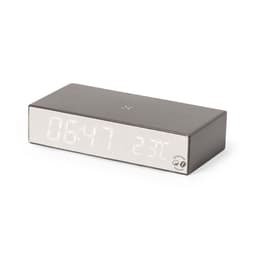 A grey wireless charging clock with a large digital display showing time and temperature. It features a logo.