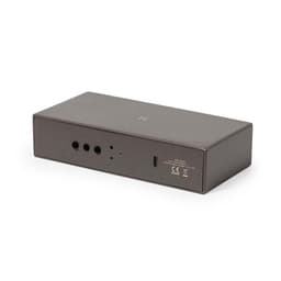 A wireless charger in a sleek black design with ports and a logo on the side.
