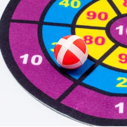 A colourful dartboard with sections marked in yellow, purple, and pink, featuring a red ball with white stripes.