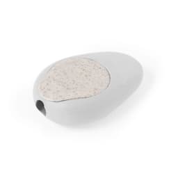 A grey pencil sharpener shaped like a pebble, featuring a speckled top surface and a hole for sharpening.