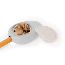 A grey pencil sharpener with a wooden handle and a removable lid, displaying collected pencil shavings inside.