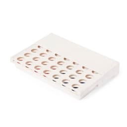 A rectangular white game box with multiple circular holes, partially revealing colourful game pieces inside.
