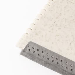 A keyring ice scraper in cream with a textured grey rubber edge, featuring a logo.