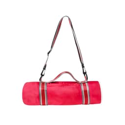 A pink blanket bag with a striped strap, designed for easy carrying and storage. Features a simple logo.