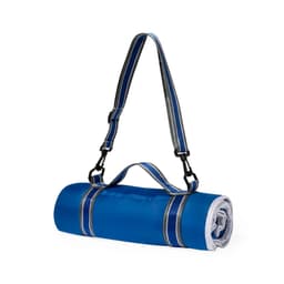 A blue picnic rug is rolled up and secured with a strap, featuring a handle for easy carrying. It has a logo on it.