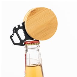 A bamboo top with a black multi-tool attached, positioned over a glass bottle, featuring a crown cap.
