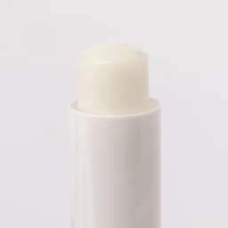 A lip balm in a white tube, with a smooth, clear balm visible at the top. The product has a logo on the packaging.