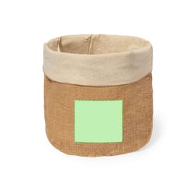 A jute bread basket with a natural beige linen top and a blank green label on the front. It features a rustic design.