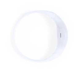 A white novelty item with a sleek circular design, featuring a small element for charging or connectivity.