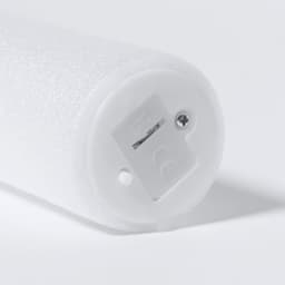 A white foam handle with a circular base featuring a small slot and screw. The item has a branding logo.