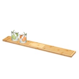 A bamboo bar mat with grooves, featuring two glasses of colourful drinks with fruit garnishes.