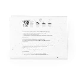 A notebook with a textured, speckled white cover, featuring illustrations of planting instructions and a logo.