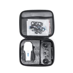 A compact black case containing a white drone and black controller, with additional accessories and documentation inside.