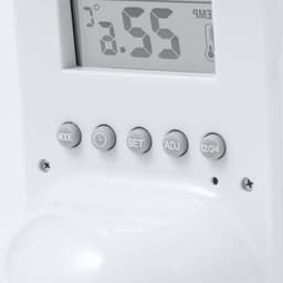 A white weather station featuring a digital display, buttons for setting, and a temperature reading.