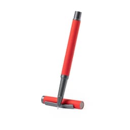 A metal pen in red with a grey tip, positioned upright next to its cap, featuring a simple logo.