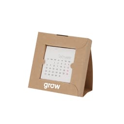 A desk calendar featuring a cardboard frame, displaying a monthly calendar page for October with green and red highlights.